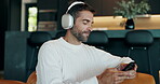 Streaming, relax and man with headphones, home and browsing playlist for entertainment and online. House, scroll and person with smartphone for song, resting and listening to music in living room