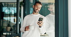 Phone, coffee and man by window in morning at home reading online blog for world news report. Cappuccino, cellphone and male person drinking caffeine latte with politics tabloids in apartment.