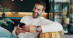 Reading, smile and phone with man on sofa for communication, social media and chat. Networking, conversation and connection with person and mobile in living room at home for scroll, online and post