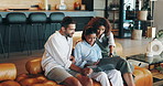 Laptop, happy family and child on sofa for learning, education and reading ebook story in home. Computer, interracial mother and father with girl for online course, teaching or parents talk together