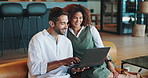 Interracial, couple and happy with laptop on sofa for online shopping, internet browsing and planning together. People, relax and smile with tech in home for streaming subscription and conversation