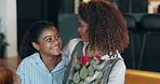 Woman, girl and flowers with hug for mothers day on sofa with care, love and gratitude for surprise. African people, mother and daughter with embrace, bouquet and roses with present in family house