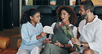 Father, girl and surprise on mothers day with flowers, gift or heart card in living room at house. Parents, man and woman with child, bouquet and happy for present, wow or love in lounge at apartment
