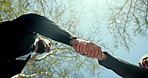 Business people, handshake and deal with meeting below or blue sky at park for partnership or agreement. Low angle, employees or colleagues shaking hands with greeting for team introduction in nature