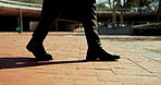 Business person, legs or walking with briefcase in city for travel, trip or local commute to work. Shoes, feet and formal fashion strolling with bag for new career or job opportunity in an urban town