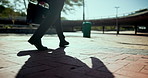Business person, legs or walking with briefcase for work trip, commute or travel in city. Employee, shoes or strolling with bag or suit for immigration, new career or job opportunity in an urban town