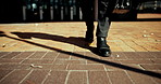 Person, legs or walking with briefcase in city for travel, business trip or local commute to work. Shoes, feet or employee strolling with bag for career journey or job opportunity in an urban town