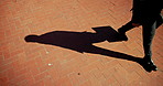 Business person, legs or walking with shadow in city above for travel, trip or local commute to work. Shoes, feet or employee with briefcase for career or job opportunity on space in an urban town