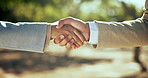 Business people, handshake and meeting with teamwork for partnership, agreement or thank you at outdoor park. Closeup, employees or colleagues shaking hands with trust or support for deal together