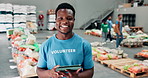 Volunteer, face and happy with tablet in warehouse for food supplies, inventory management or stock tracking for charity. NGO, community service or man with digital app for grocery donation checklist