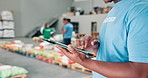 Hands, man or volunteer with tablet in warehouse for charity help or community service app. Nonprofit outreach, notification or NGO activist with technology for online donation, inventory or poverty