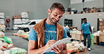 Writing, smile and man with clipboard, volunteer and organised for nonprofit in community center. Social responsibility, charity and inventory for gifts in ngo, donation and inspection with info