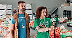 Tablet, communication and volunteers at food drive donation for community outreach with groceries. Checklist, conversation and NGO workers with planning for charity service in workshop for nonprofit.