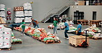 Food drive, packing and passing with volunteer people in community center for activism. Collaboration, social responsibility and throwing with humanitarian team organizing or planning donations