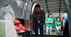 Aid, food drive and van with volunteer people unpacking donations for community outreach. Charity, NGO and teamwork with non profit group collecting groceries in vehicle for social responsibility