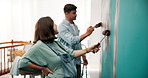 Painting, love and smile with couple in baby room for  interior design, color choice or wall decor. Home improvement, pregnancy and support with man and woman in apartment for nursery planning