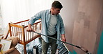 Diy, man and painting a wall in home for nursery renovation, bedroom makeover or house improvement for baby arrival. Interior design, person and nesting with decoration process, fatherhood or painter