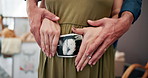Hands, couple and stomach with pregnancy ultrasound, baby scan and maternity wellness. Pregnant woman, xray picture and partner support with growth development, family planning and prenatal at house