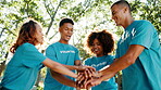 Outdoor, people and hands in huddle for volunteering, motivation and success for community service. Team, men and women with stack for support, celebration and happy for social responsibility program