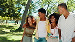 Happy people, hug and friends in nature walking for bonding, social gathering and outdoor park. Fun, men and women with smile, laugh and love for talking on holiday, vacation or adventure in garden