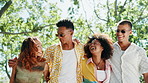 Happy, hug and friends in nature walking for bonding, social gathering and outdoor park. Fashion, men and women with smile, laugh and love for talking on holiday, vacation or adventure on fun weekend