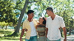 Surprise, hug and friends in nature walking for bonding, fun social gathering or outdoor park. Excited, men or woman with smile, laugh or love for talking on holiday, vacation or adventure on weekend