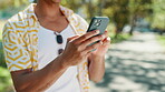 Online, hands and scroll with phone at park for social media post, internet news or streaming service. Closeup, person or smartphone for web browsing, app download or reading blog information outdoor