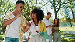 Friends, group and walking with talking at park for nature adventure, explain story and bonding outdoor. Gen z, happy people and stroll together in road for holiday, weekend break and conversation