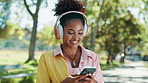 Nature, cellphone and woman with headphones for walk outdoor in park listening to music online. Happy, phone and female person streaming playlist, podcast or radio on app with audio tech in garden.