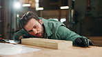 Carpentry, woodwork and man in factory with dust on wood for furniture, manufacturing and lumber production. Construction, workshop and carpenter blowing for planks, timber and board for renovation