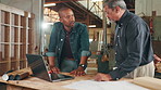 Teamwork, carpentry or people on laptop for manufacturing, project or furniture production in warehouse. Mentor teaching, carpenter apprentice or online for timber, lumber or construction business