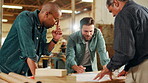 Men, carpenter and talk with blueprint in workshop for ideas, manufacturing and furniture process. Staff, brainstorming and woodwork for production warehouse, crafting project and skill development