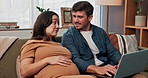 Laptop, pregnancy and happy with couple on sofa for growth progress, baby milestones and research. Child care blog, home and trimester update with man and woman in living room for family planning