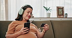 Pregnant woman, smile and credit card with phone for online shopping, maternity ecommerce and payment. Person, headphones and digital with medical expenses, baby items and pregnancy podcast at house