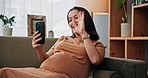 Phone, video call and wave with pregnant woman on sofa in living room of home for maternity leave. Hello, pregnancy and smile with happy prenatal person in apartment for communication or greeting