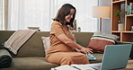 Happy, pregnant woman or laptop with video call for baby clothing, chat or preparation on sofa at home. Female person, pregnancy or computer with wave for communication, motherhood or conversation
