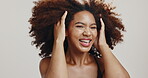 Hair, afro and black woman with wind for wellness, shine and natural glow on white background. Salon, luxury beauty and happy girl smile with curly hairstyle, texture and glamour growth treatment