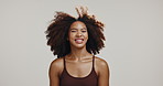 Face, smile and woman in studio, hair care and beauty with confidence on gray background. Portrait, person and happy model with mockup space, texture and volume with curls, treatment and grooming
