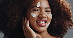 African woman, skincare and face in studio with beauty, smile and excited for change by background. Girl, model and happy in portrait with lotion, creme and dermatology with cosmetics in Nigeria