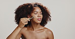 Beauty, skincare and woman with jade roller in studio for glowing skin, lymphatic drainage or detox circulation. Girl, cosmetics tool and massage face for dermatology or self care on white background