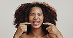 Happy, smile and face of black woman in studio for dental hygiene, gum disease and oral care. Health, mouth and portrait of person pointing for wellness, cleaning and fresh breath on white background