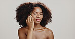 Beauty, skincare and girl with jade roller in studio for glowing skin, lymphatic drainage and detox circulation. African person, cosmetics tool and massage face for dermatology on white background
