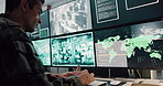 Military, man and typing on computer screen in control room, battle location and monitor war. Soldier, feedback or global surveillance of satellite warning, government protection and secret services
