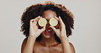 Skincare, beauty and woman with lemon in studio with tongue out for dermatology on white background. Citrus fruit, natural cosmetics and happy African model with organic vitamin c, detox and health