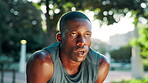Fitness, tired and man on break, breathing and sweating in nature, runner and outdoor for workout. Park, exhausted and black person with fatigue in morning, exercise and practice for marathon or race
