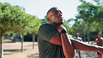 Man, fitness and stretching with arm at park for workout preparation, exercise or outdoor training. Active, male person or breathing with warm up routine for flexibility, balance or physical activity