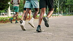 Group, legs and running for cardio, fitness and wellness in park for urban marathon club. Friends, people and sneakers for health, workout and exercise or endurance training with personal trainer
