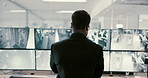 Man, back and security with screen of surveillance in control room for monitoring safety in building. Male person, CCTV operator or mall cop with display on computer for area footage or observation