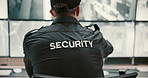 Back, security guard and man with video surveillance, uniform and computer with safety service. Person, employee or officer in workplace, info or control room with inspection, camera or investigation