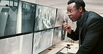 Black man, security guard and screen with radio for surveillance alert or building safety. Male person, CCTV operator or mall cop with speaker or display for communication, footage or observation